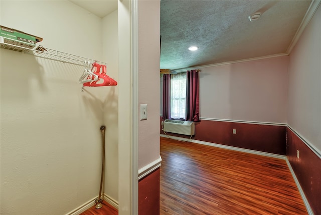 interior space featuring hardwood / wood-style floors and a wall mounted air conditioner