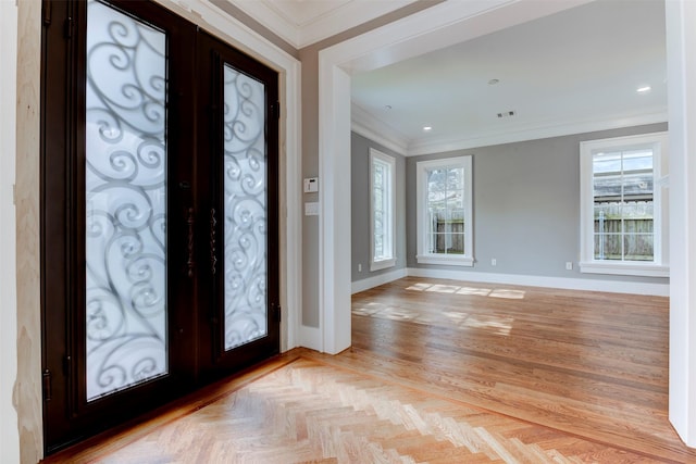 entrance foyer featuring crown molding, a wealth of natural light, and french doors