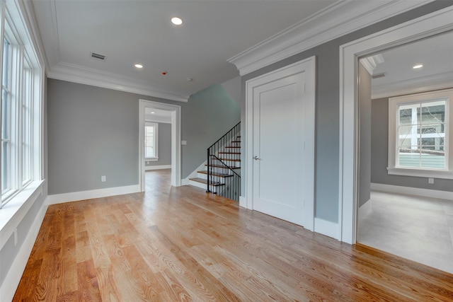 unfurnished room featuring crown molding and light hardwood / wood-style flooring