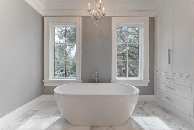 bathroom featuring ornamental molding, a bath, and a chandelier