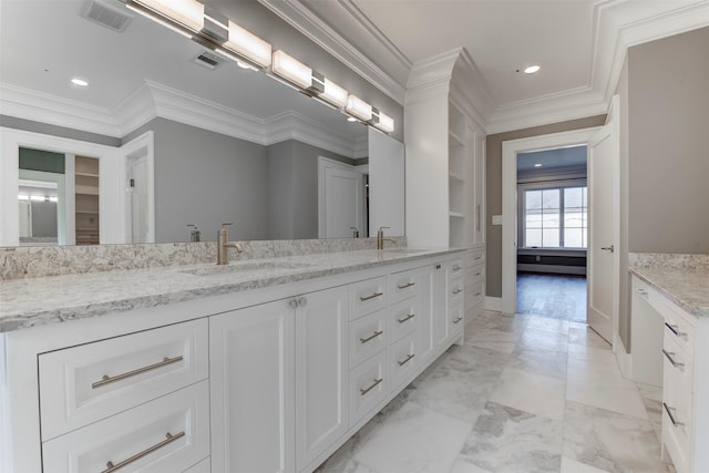 bathroom featuring crown molding and vanity