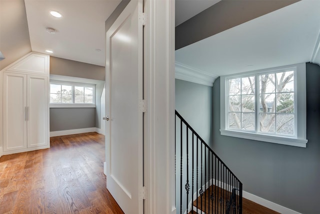 corridor featuring hardwood / wood-style flooring and vaulted ceiling