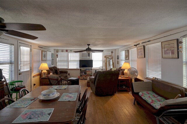 dining area with hardwood / wood-style floors, ceiling fan, a healthy amount of sunlight, and a textured ceiling