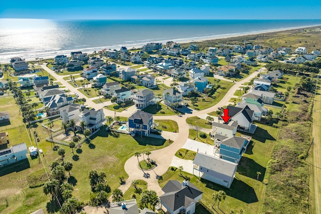 bird's eye view with a water view and a beach view