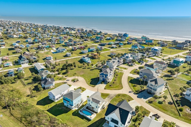 drone / aerial view featuring a water view and a beach view