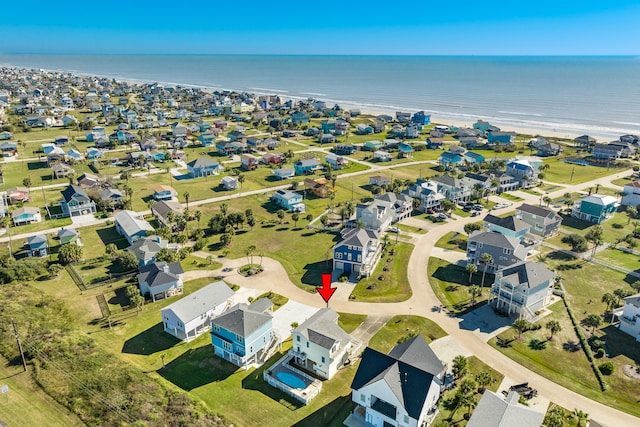 drone / aerial view featuring a water view and a beach view