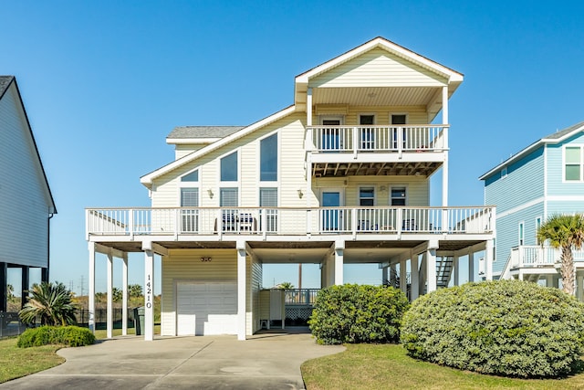 coastal inspired home with a balcony and a garage