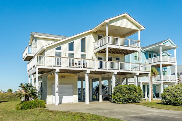 back of house featuring a balcony and a garage