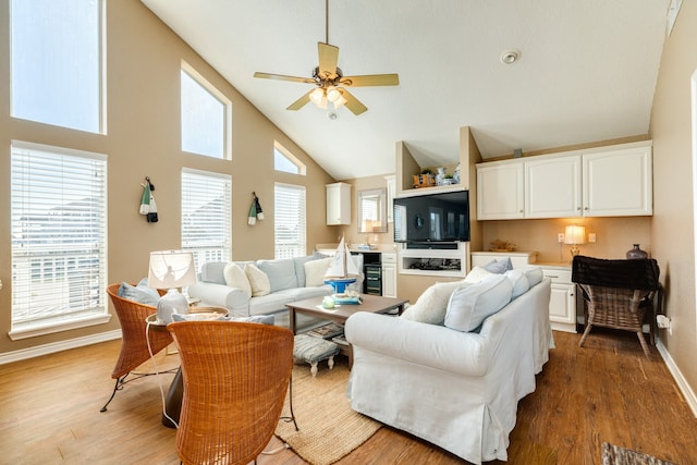 living room featuring ceiling fan, hardwood / wood-style flooring, and a healthy amount of sunlight