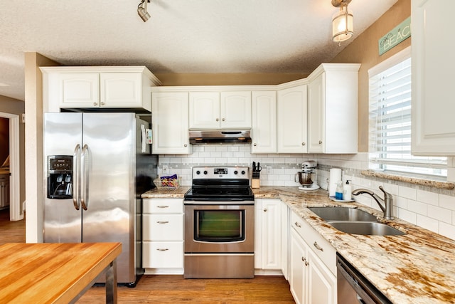 kitchen featuring white cabinets, a textured ceiling, and appliances with stainless steel finishes