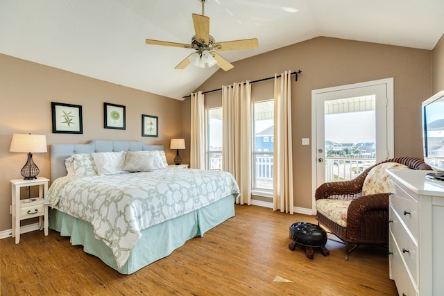 bedroom featuring light hardwood / wood-style floors, lofted ceiling, ceiling fan, and access to exterior