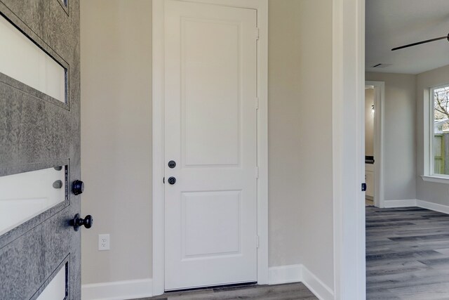 foyer with dark hardwood / wood-style floors and ceiling fan