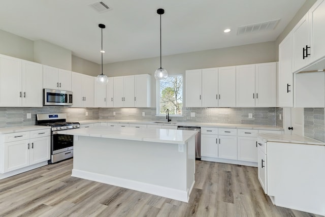 kitchen with white cabinets and appliances with stainless steel finishes