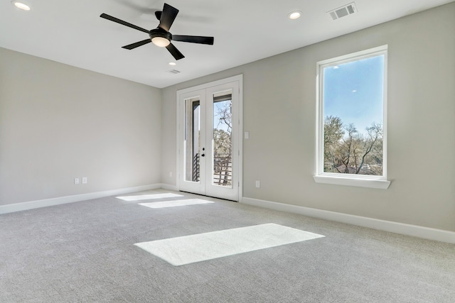 spare room with carpet flooring, ceiling fan, french doors, and a healthy amount of sunlight