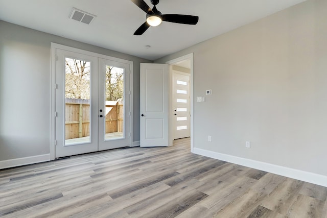 spare room featuring ceiling fan, french doors, and light hardwood / wood-style flooring