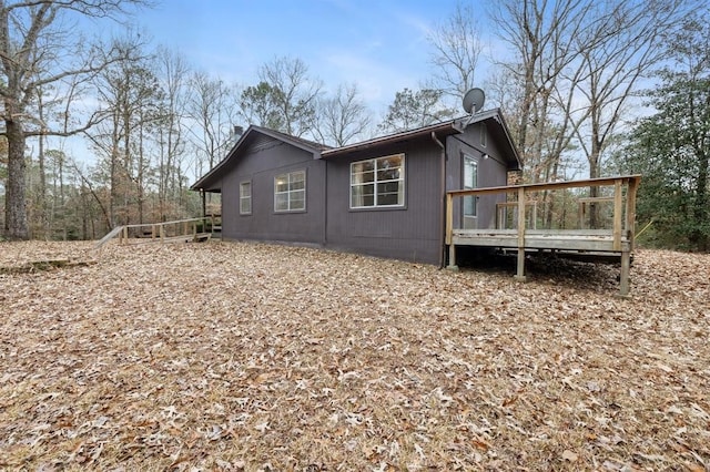 rear view of house featuring a deck