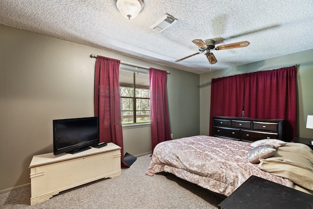 carpeted bedroom with a textured ceiling and ceiling fan