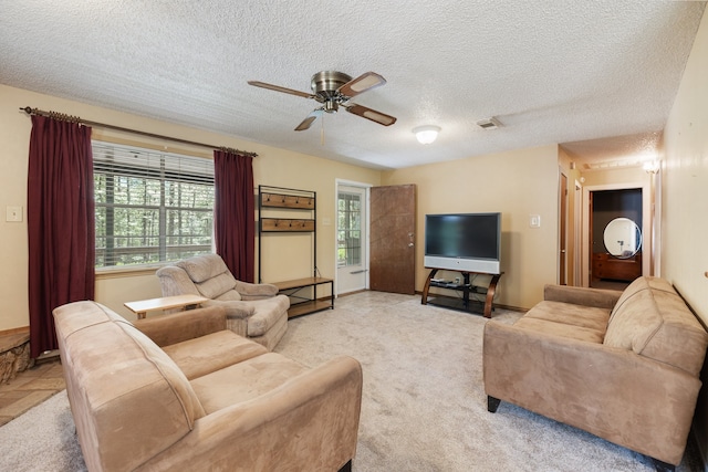 carpeted living room with a textured ceiling and ceiling fan