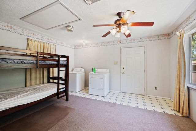 unfurnished bedroom with a textured ceiling, ceiling fan, and independent washer and dryer