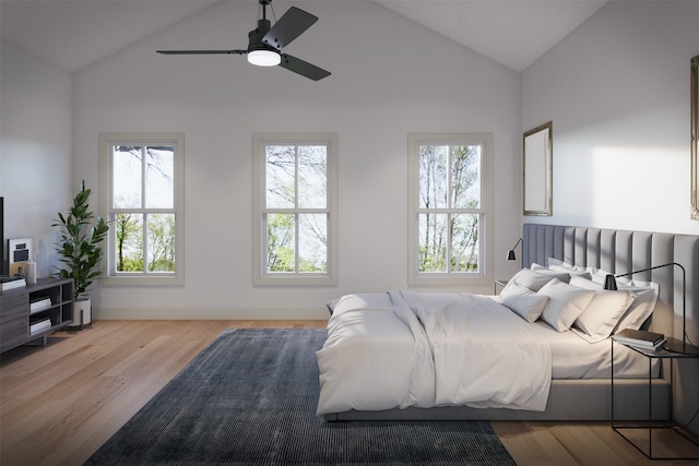 bedroom featuring light wood-type flooring, lofted ceiling, ceiling fan, and multiple windows