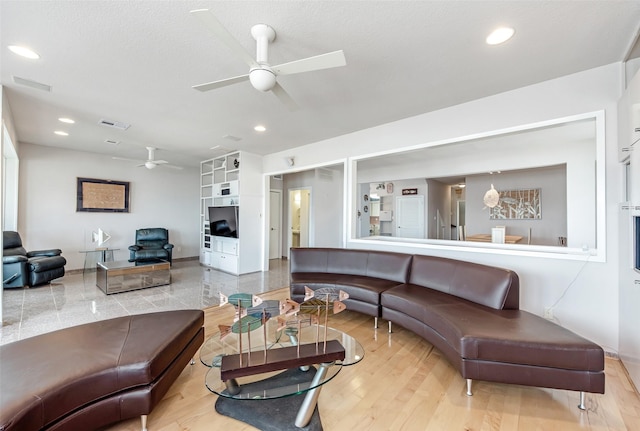 living room with wood-type flooring and ceiling fan