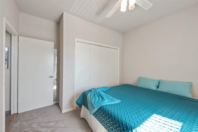 carpeted bedroom featuring ceiling fan and a closet