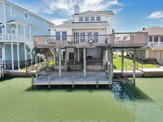 rear view of house with a deck with water view