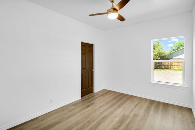 empty room with light hardwood / wood-style floors and ceiling fan