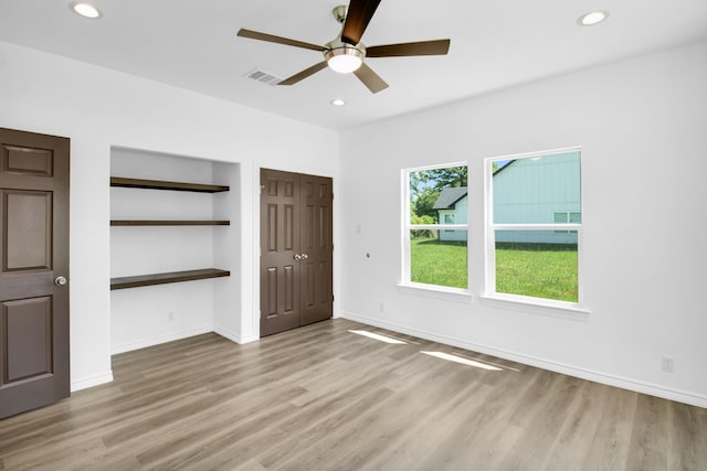 unfurnished bedroom featuring light hardwood / wood-style flooring and ceiling fan