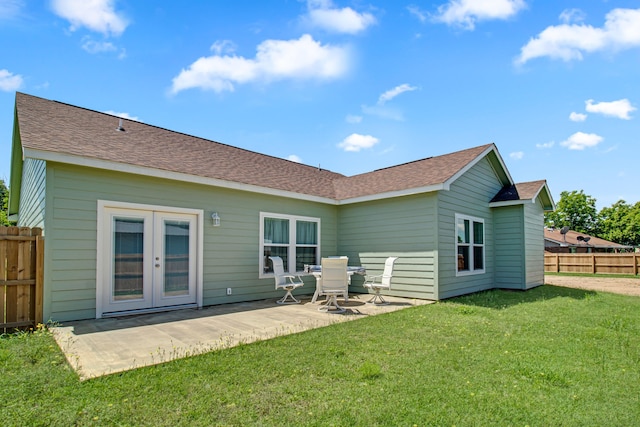 rear view of house with a patio, a yard, and french doors