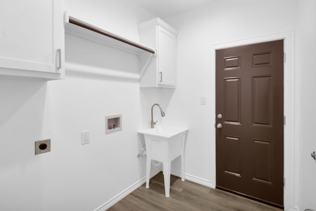 laundry room featuring washer hookup, dark hardwood / wood-style floors, electric dryer hookup, and cabinets