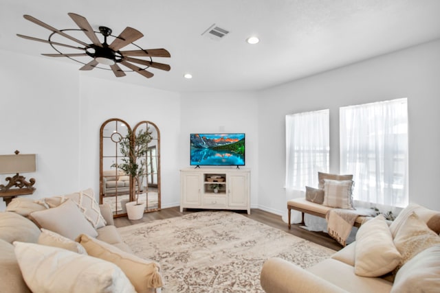 living room with wood-type flooring and ceiling fan