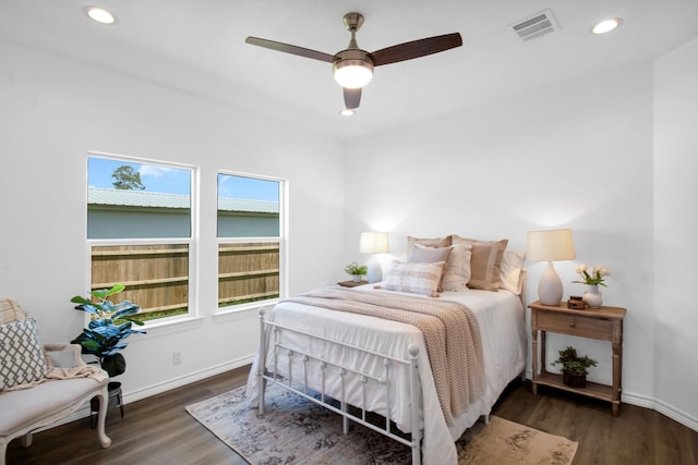 bedroom with ceiling fan and dark hardwood / wood-style floors