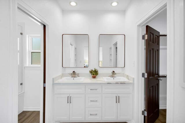 bathroom with vanity and hardwood / wood-style floors