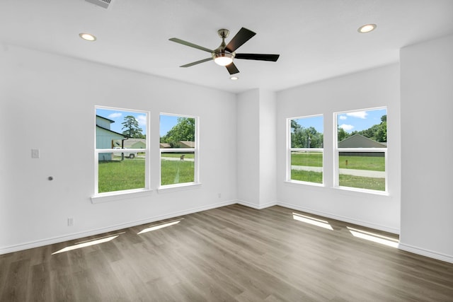 empty room featuring ceiling fan and hardwood / wood-style floors