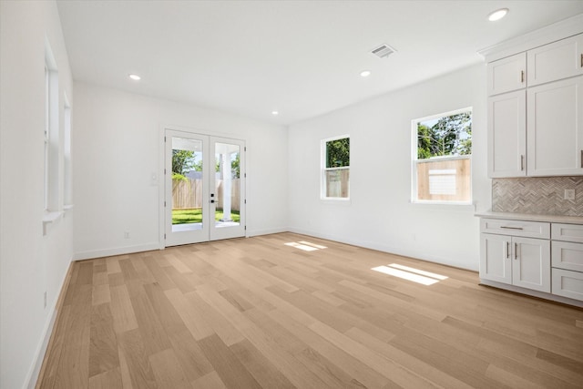 interior space with light wood-type flooring and french doors