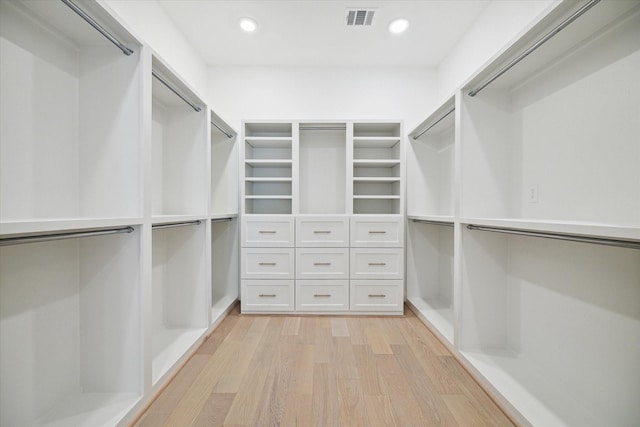 spacious closet featuring light hardwood / wood-style flooring