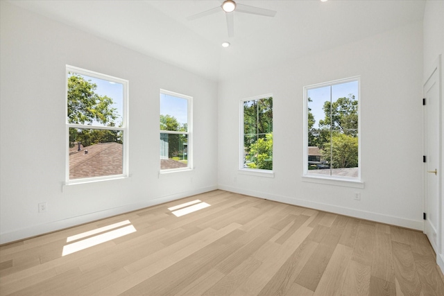 unfurnished room featuring a wealth of natural light, ceiling fan, and light wood-type flooring