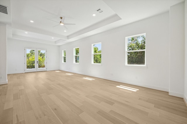 empty room with light hardwood / wood-style floors and plenty of natural light