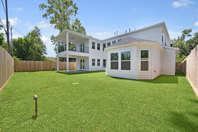 back of property featuring a lawn, french doors, a balcony, and a patio