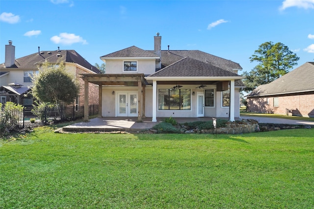 rear view of property featuring ceiling fan, a yard, and french doors