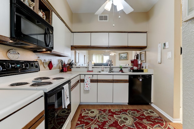 kitchen with white cabinets, sink, light hardwood / wood-style floors, and black appliances