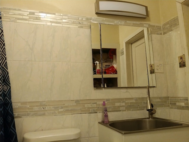 bathroom featuring tile walls, toilet, and tasteful backsplash