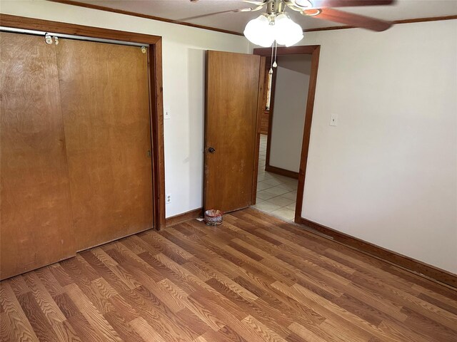 unfurnished bedroom featuring a closet, ceiling fan, and wood-type flooring