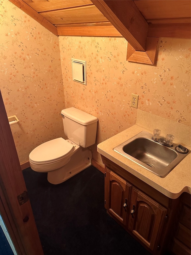 bathroom with wooden ceiling, vanity, and toilet