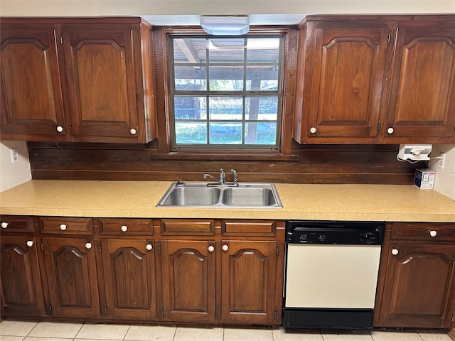 kitchen featuring dishwasher, light tile patterned floors, and sink