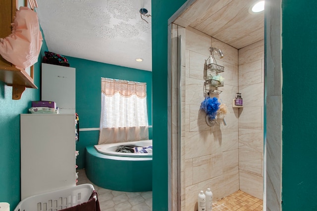 bathroom featuring tiled shower, a textured ceiling, and tile patterned flooring