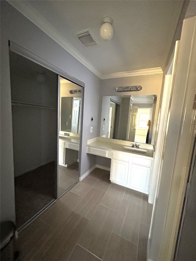 bathroom featuring vanity, crown molding, and tile patterned floors