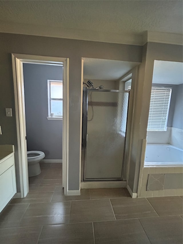 full bathroom with shower with separate bathtub, tile patterned floors, toilet, and vanity