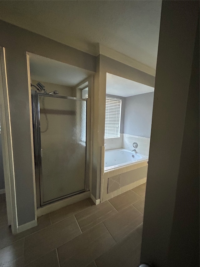 bathroom featuring independent shower and bath and tile patterned floors